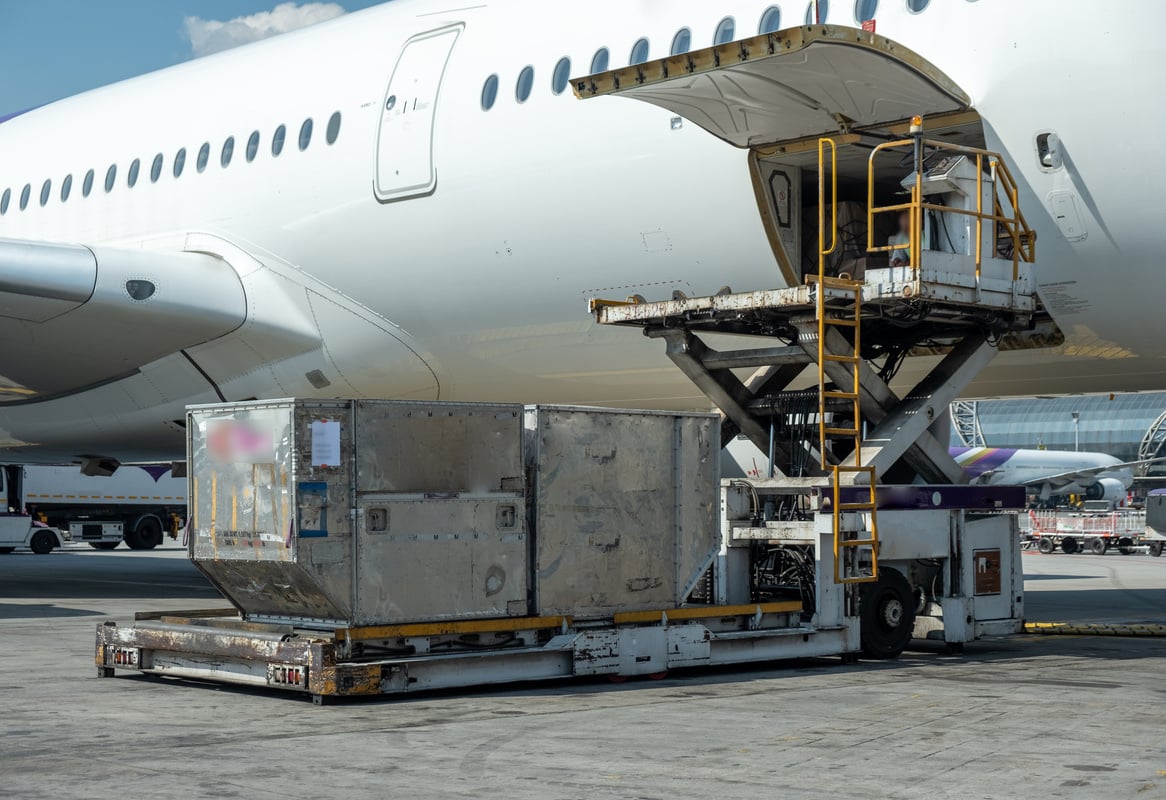 Air cargo logistic containers are loading to an airplane.